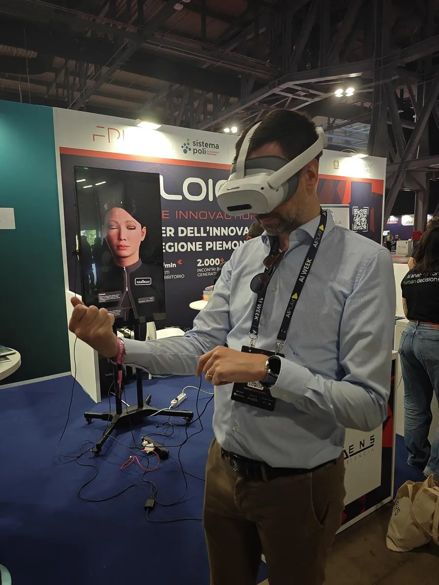 Visitor trying a virtual reality experience with PICO headset at the DeuSens booth at AI Week 2026 with Alice Assistant avatar