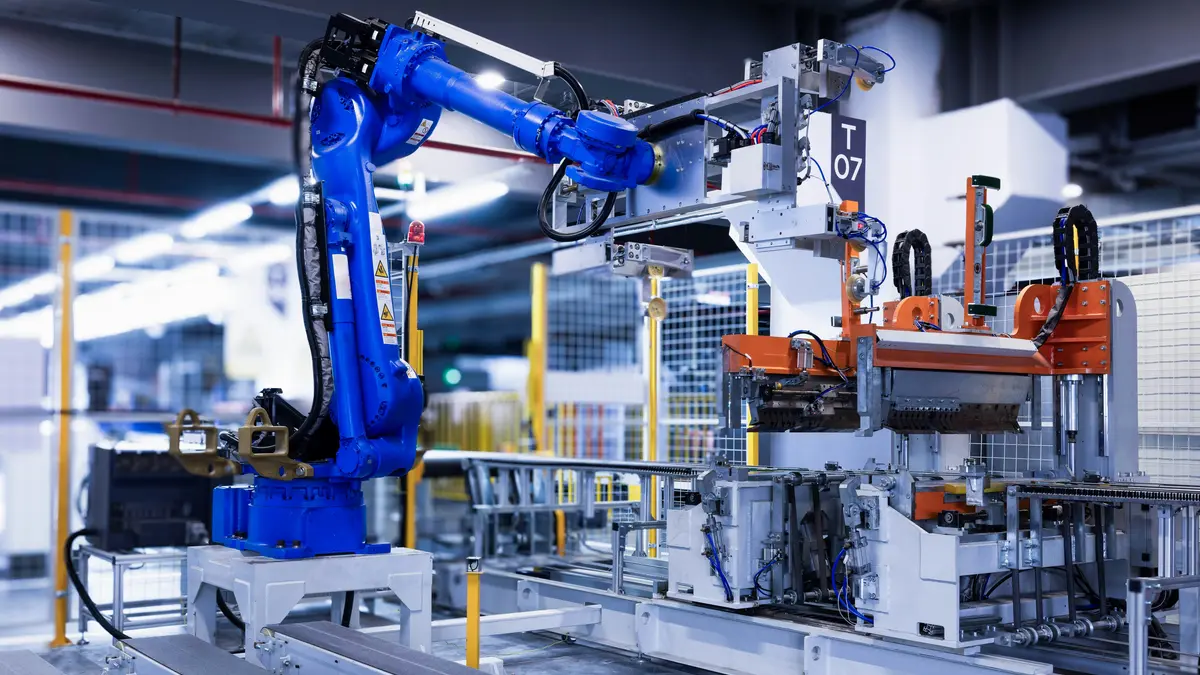 Blue industrial robotic arm working on a real production line